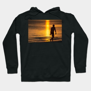 Silhouette of man in the golden light at St KIlda Beach, Melbourne. Hoodie